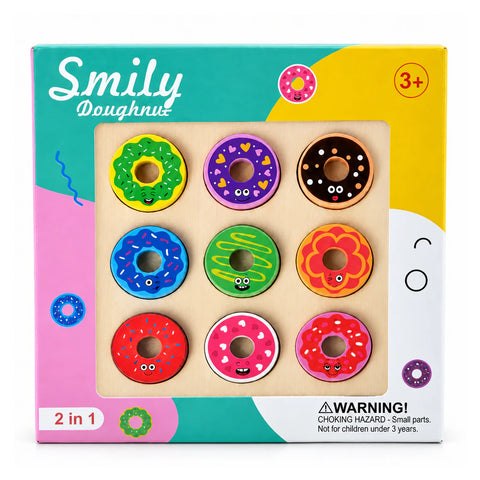 علبة Smily Doughnut 2 في 1 لسن 3+، فيها تسع قطع دوناتس ملونة في لوحة خشب